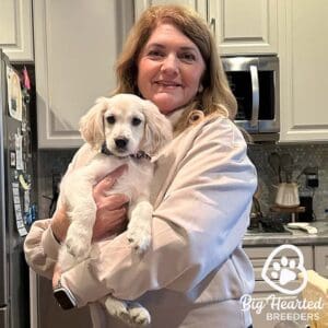 Woman holding a miniature Golden Retriever