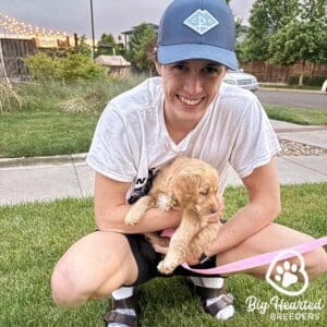 Young man holding a mini Golden Retriever puppy who has no problem of puppy biting